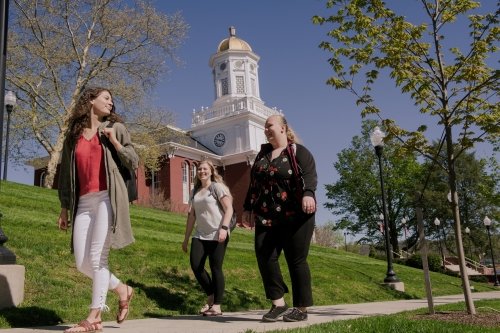 Students walking in front of Carver Hall during the Spring