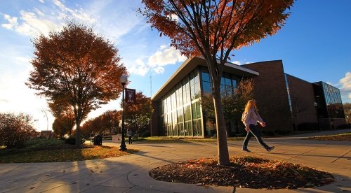 Student walks by McCormick Center as the sun sets in late fall